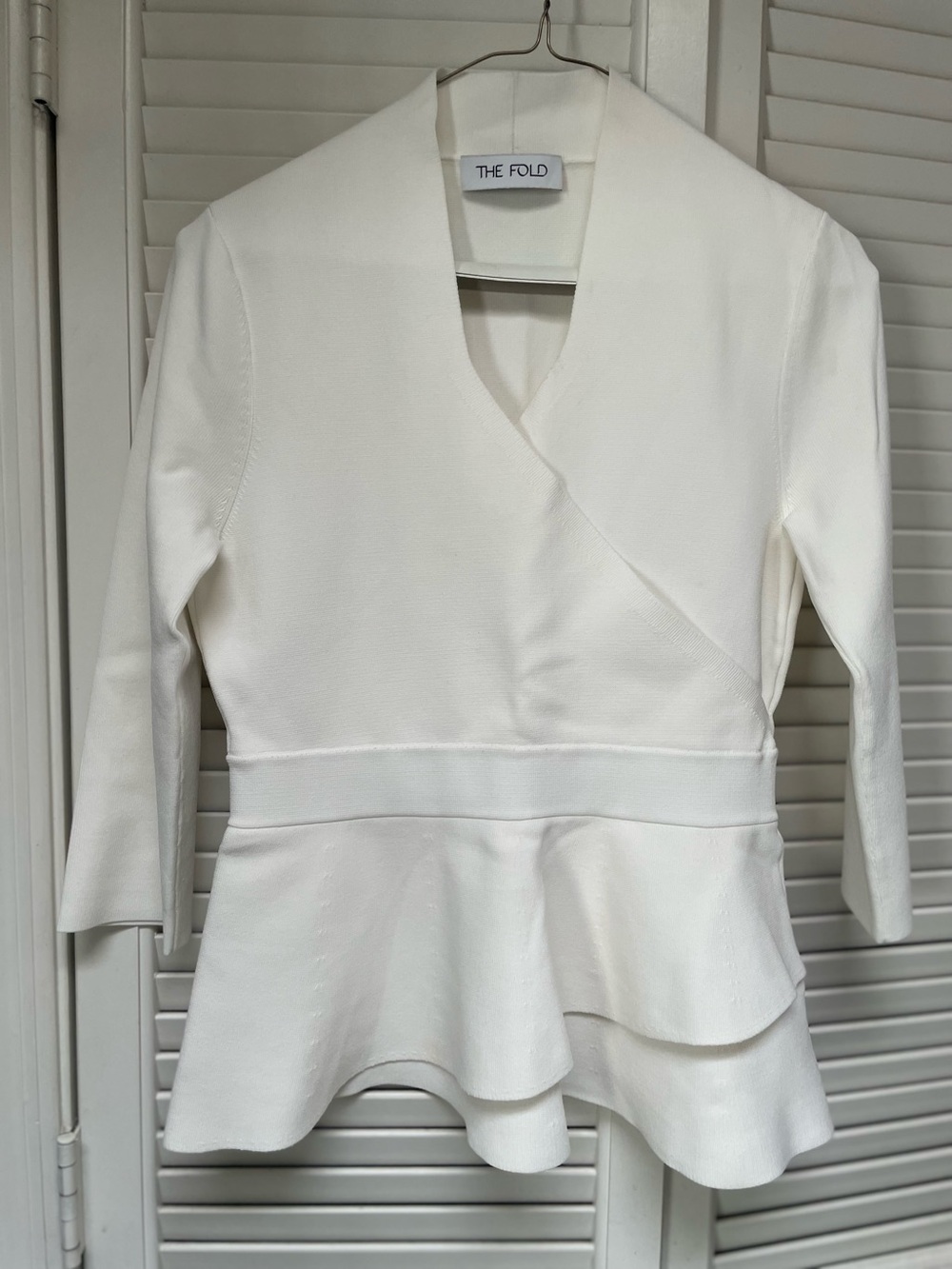 Tight knit white v-neck peplum top